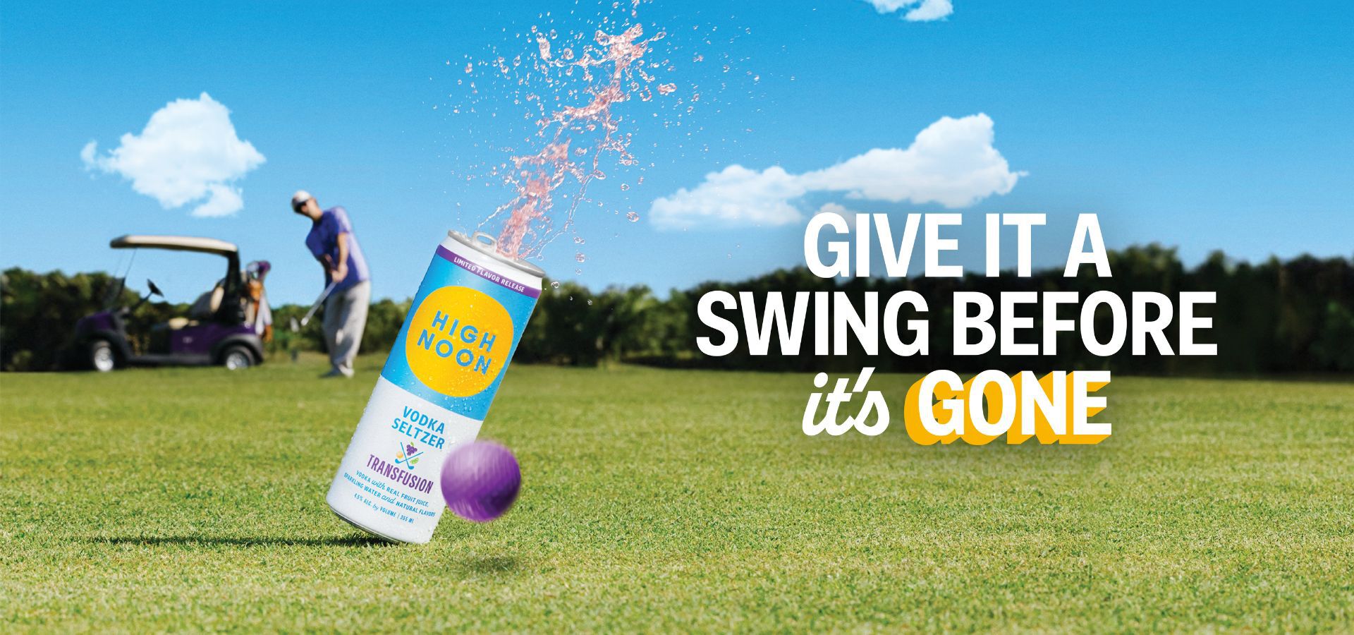 High Noon Transfusion vodka seltzer can splashing open on a golf course with a golfer and cart in the background under a bright blue sky